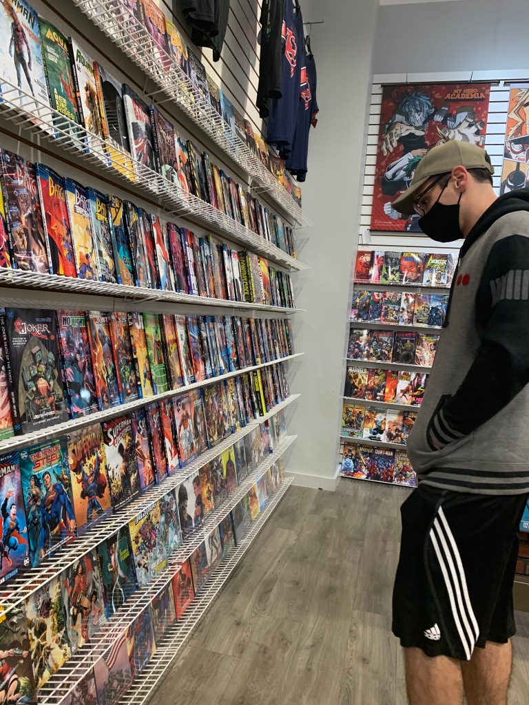 Matt McClellan checks out one of the comic book walls at Adventureland Store in Blackwood, NJ. November 2, 2020, Photo/ Julia Riffle.
