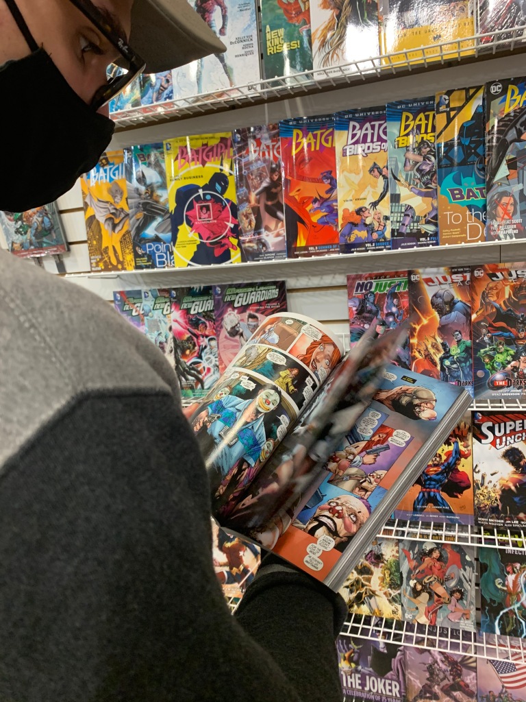 Matt McClellan flips through "Batman: Death of the Family" at Adventureland Store in Blackwood, NJ. November 2, 2020, Photo/ Julia Riffle.
